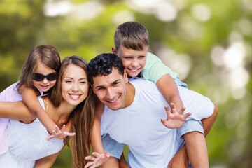 Young happy family with children playing in park