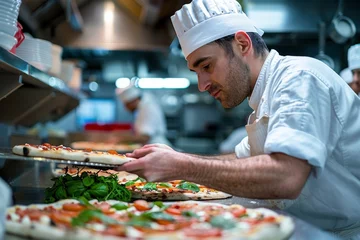 Keuken spatwand met foto Pizza chef finishing the preparing of in professional pizzeria restaurant kitchen. © jakapong