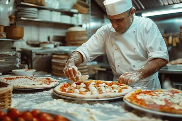 Poster Pizza chef finishing the preparing of in professional pizzeria restaurant kitchen. © jakapong