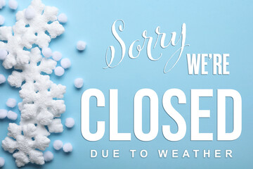 Sorry we are closed due to weather sign. Text and snowflakes on light blue background