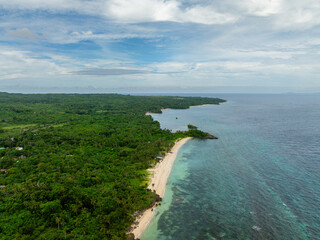 Carabao Island with green forest and white sandy beaches at coast. San Jose, Romblon. Philippines.