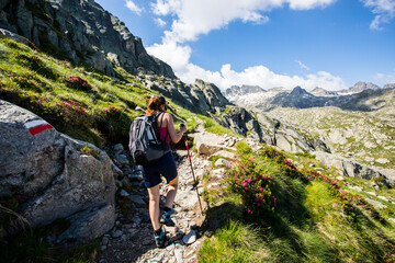 Young hiker girl summit to Ratera Peak in Aiguestortes and Sant Maurici National Park, Spain