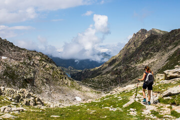 Naklejka na ściany i meble Young hiker girl summit to Ratera Peak in Aiguestortes and Sant Maurici National Park, Spain