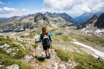 Young hiker girl summit to Ratera Peak in Aiguestortes and Sant Maurici National Park, Spain