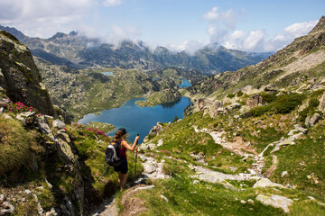 Young hiker girl summit to Ratera Peak in Aiguestortes and Sant Maurici National Park, Spain