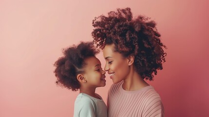 Happy African american mother and daughter looking at each other on pink background. Mother's day - obrazy, fototapety, plakaty