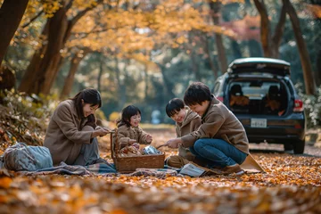 Fotobehang family from the Asia Pacific region takes a break from their road trip to enjoy a picnic.  © Kamonwan
