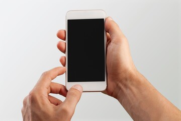 Hand holding modern smartphone with a blank screen