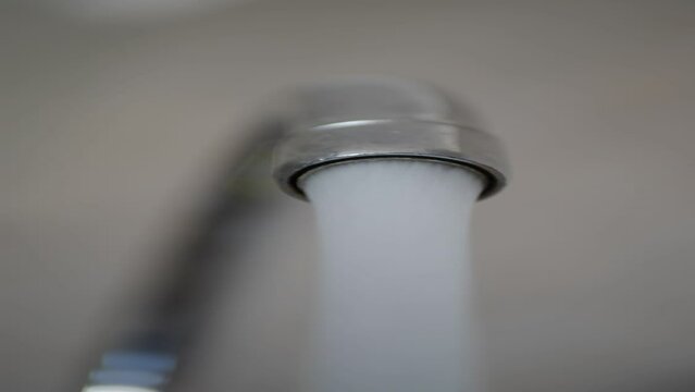 water pouring from a faucet tap slow motion 