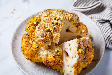 Spicy baked cauliflower with tahini dressing and pistachios.