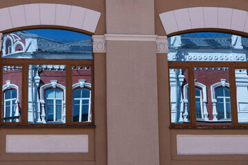 Windows that reflect the facade of an old building. Background.