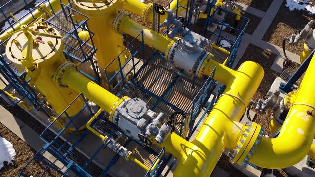 An aerial view captures a beautifully landscaped gas pumping sector, with vibrant yellow fuel pipes adding a distinctive and intriguing element to the overall landscape