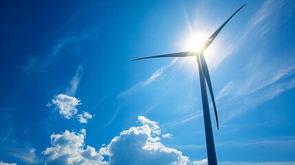 Close up of wind turbine on blue sky background with shinink sun