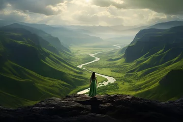 Foto op Plexiglas a woman standing on a mountain looking at a river © Eduard