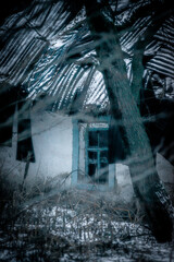 Fototapeta na wymiar Abandoned house in the forest village at winter. Mystery landscape archittcture. Evening at village. Snow on the roof