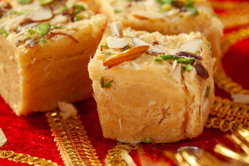 Traditional Indian sweets on a decorative red fabric