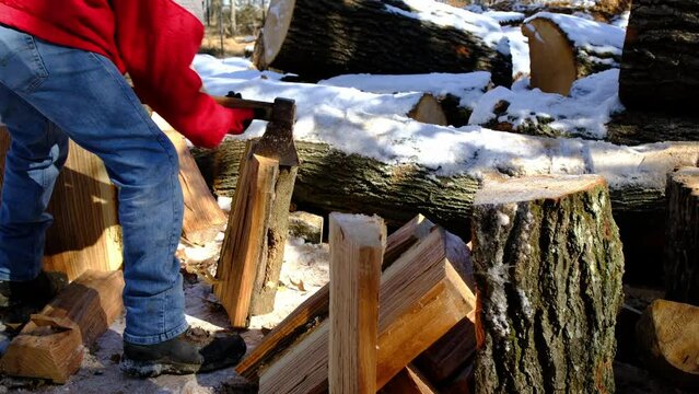 Slow motion while piece of oak wood being impaled onto Russian ax and then flip to strike stump ax head first using gravity force trying split log.