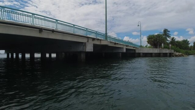 POV from a personal watercraft in the Florida Keys going under a bridge