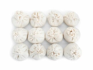 Many uncooked khinkali (dumplings) isolated on white, top view. Georgian cuisine