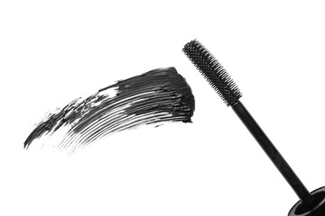Smear of black mascara and applicator isolated on white, top view