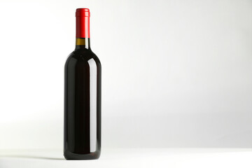 Bottle of expensive red wine on white background. Space for text