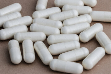 A stack of supplement capsules, dietary supplements, vitamin tablet, nutritional supplements in capsule form.