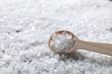 Natural salt and wooden spoon, closeup view
