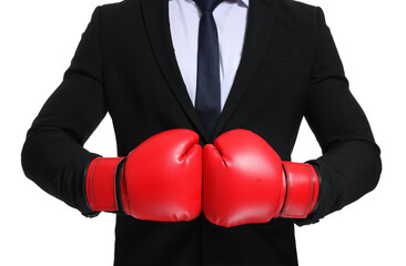 Businessman in suit wearing boxing gloves on white background, closeup