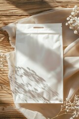 white packaging bag mockup, on a wooden table, top view with header seal
