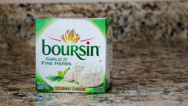 NORWALK, CT, USA - FEBRUARY 20, 2024: Package from garlic and herbs cheese from Boursin on kitchen counter