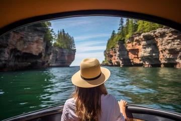 Foto op Canvas Woman enjoying a scenic boat tour of sea caves under a clear blue sky © Татьяна Евдокимова