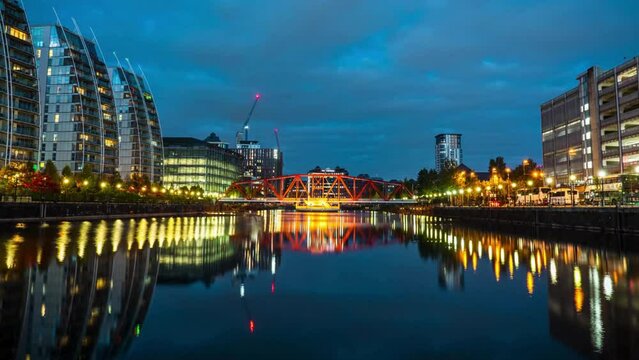 Time lapse Cityscape of Big Red Bridge and Media City UK waterfront around Salford Quays in Manchester at night, England, UK