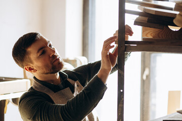 Carpenter working with wood and saw in the manufacturing industry