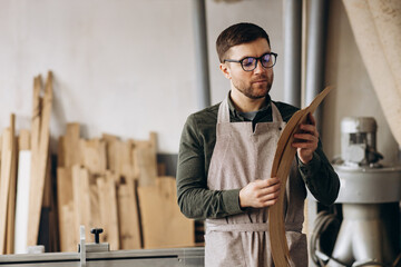 Carpenter holding veneer at the working place