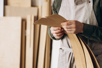 Carpenter holding veneer at the working place