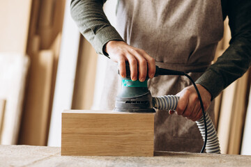 Carpenter working with wood and saw in the manufacturing industry