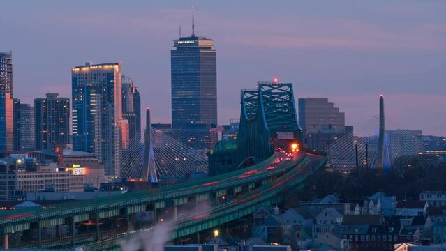 Time lapse of Boston skyline with bridge and express way over the cityscape day to night