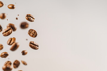 Flying coffee beans on light gray background. Concept for flyers, banners, business cards and...