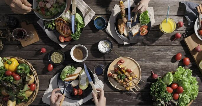 Grill steak and fresh vegetables salad served and wine on top of a wooden table outdoor garden, featuring a variety of delicious options including salads, seafood, and meats