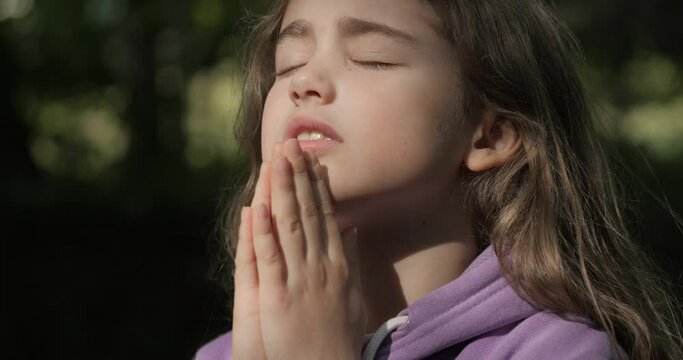 Religion. Child Girl Folded Lifestyle Her Hands in Prayer Pray to God on Outdoor. Worried Teenager Girl Looking for Hope and Faith Praying to God. Religious Child With Hope in His Heart Prays to God.