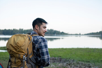 Asian tourist smiling happily Backpacker, hiking trips, outdoor activities on vacation.