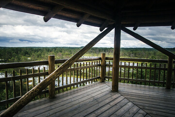 Fototapeta premium Lahemaa National Park view point. Wooden tower over swamp. Nature observatory. Nature landscape of Estonia. Aerial view of wetland.