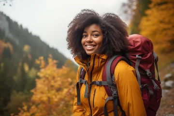 Foto op Canvas A portrait of a beautiful young African American woman relishing a mountain hike, displaying wanderlust and the thrill of mountaineering. © Darya