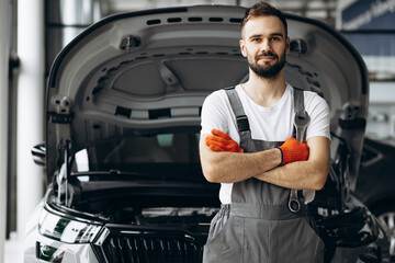 Car mechanic holding wrench for car repair
