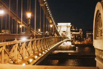Wall murals Széchenyi Chain Bridge Budapest by night landscape. Famous Széchenyi chain bridge background. Capital city of Hungary landscape. Nightlife background. People walking by night.