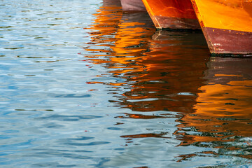 Reflection of the prows of fishing boats in the port of Mar del Plata, Argentina