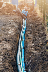 New service duct laying in the open trench to replace the new water pipe and provide new electric...