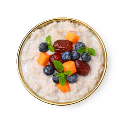 Delicious barley porridge with blueberries, pumpkin, dates and mint in bowl isolated on white, top view