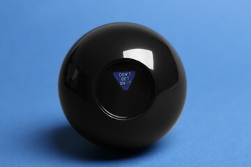 Magic eight ball with prediction Donʼt Bet On It on blue background