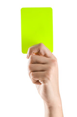 Referee holding yellow card on white background, closeup